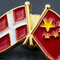 Nærbillede af venskabspin med Danmarks og Kinas flag i detaljeret glat emalje og guld